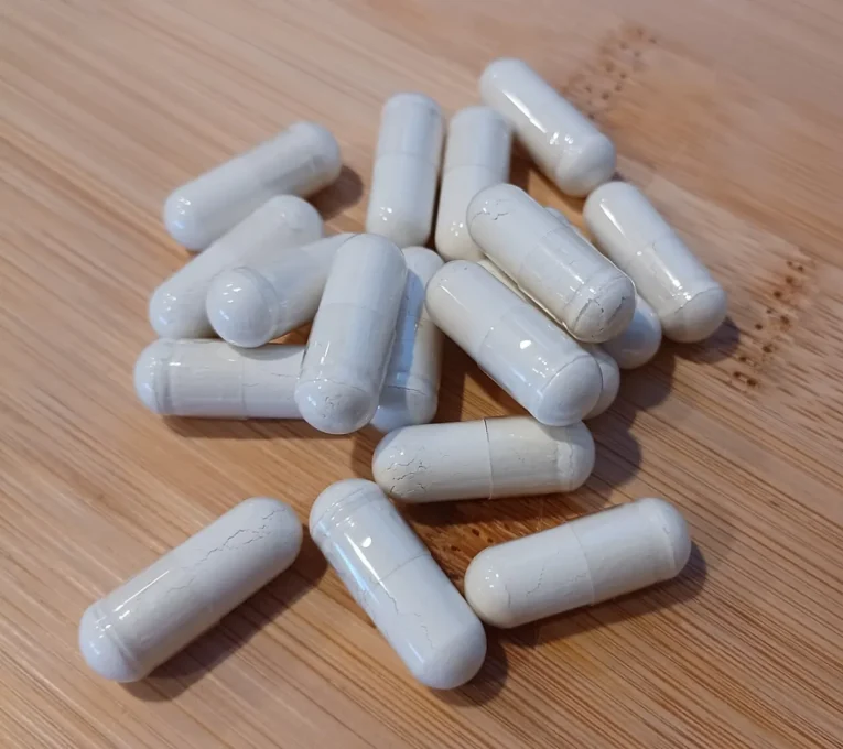 Natural Health Guides for Healthy Living 7 White dietary supplement capsules