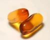 Two softgel supplement capsules