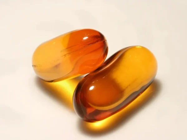 Two softgel supplement capsules