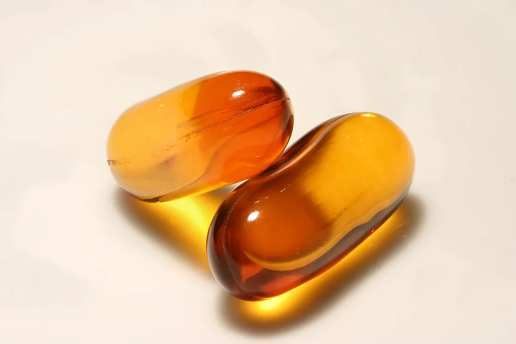 Two softgel supplement capsules